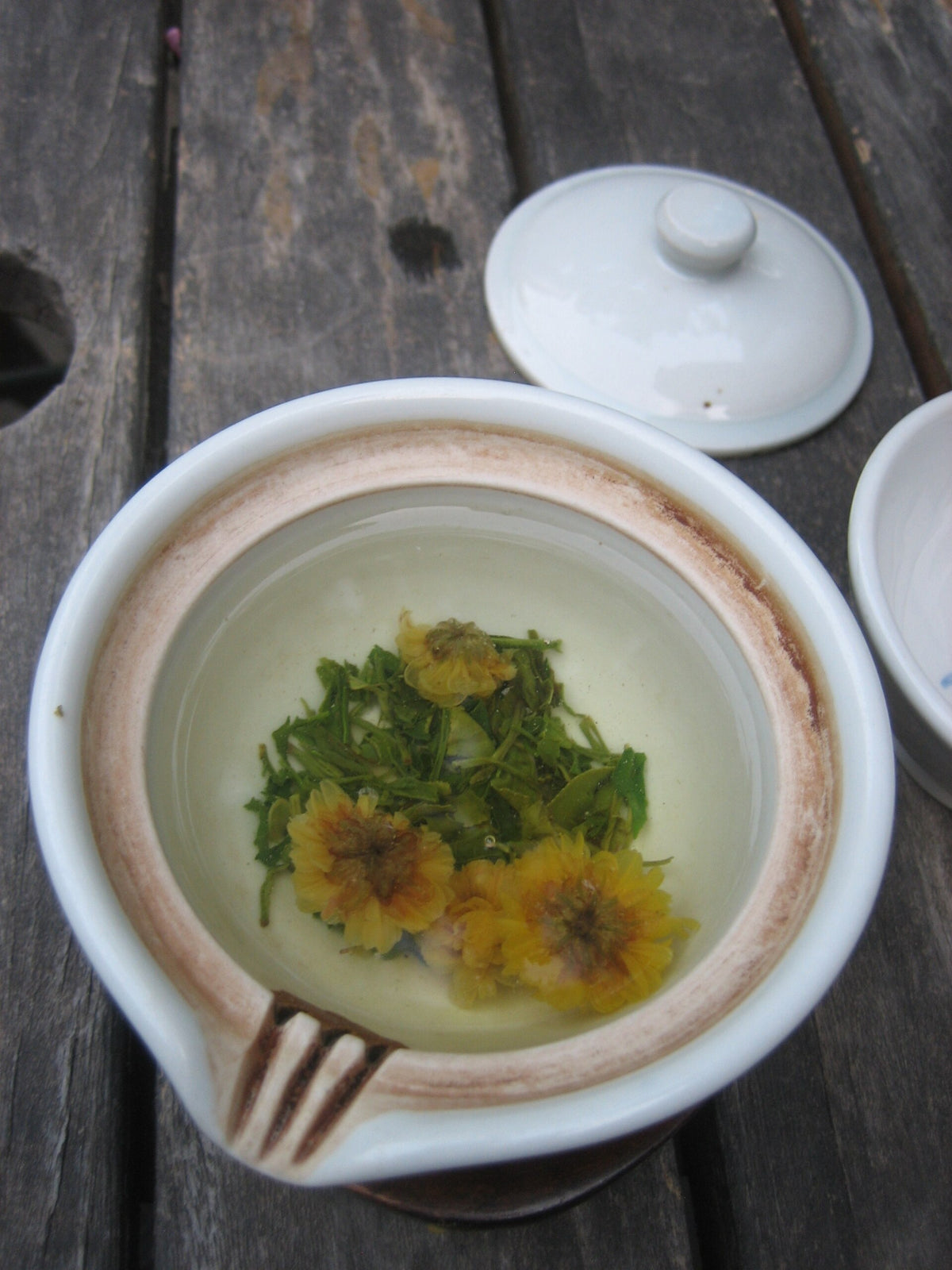A cup of golden chrysanthemum tea, Gukhwacha, brewed from dried chrysanthemum blossoms