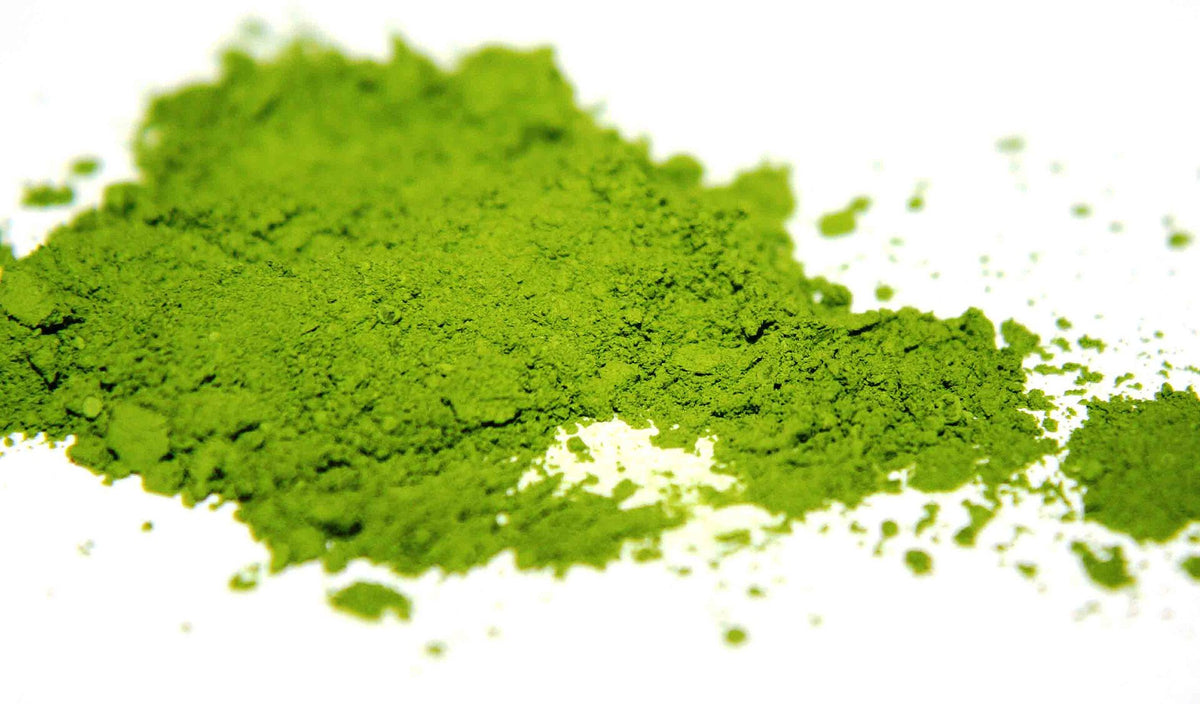 Matcha green tea powder next to jasmine tea, comparing the two calming teas